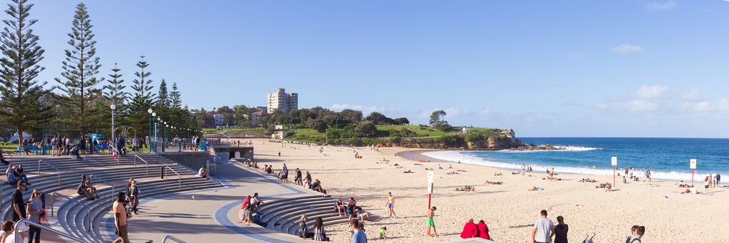 Wide view of Coogee Beach promenade, sand and ocean